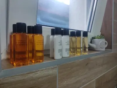 a shelf with four bottles of essential oils on it at Apartman UMA in Bihać