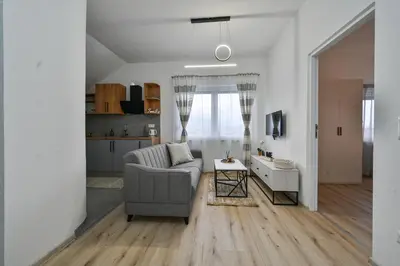 a living room with a couch and a table at Apartman UMA in Bihać