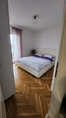 a bedroom with a bed and a wooden floor at Stan na dan Banja luka in Banja Luka