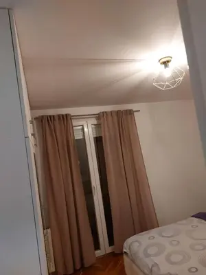 a room with a bed and a light and a window at Stan na dan Banja luka in Banja Luka