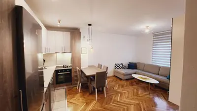 a living room with a couch and a table at Stan na dan Banja luka in Banja Luka
