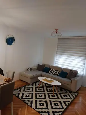 a living room with a couch and a table at Stan na dan Banja luka in Banja Luka