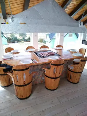 a large wooden table and chairs in a room at Apartman OGNJIŠTE in Kupres