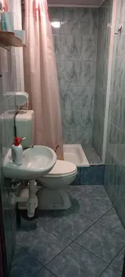 a bathroom with a toilet and a sink and a shower at Apartman OGNJIŠTE in Kupres