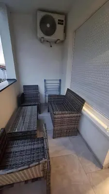 three empty benches in a room with a fan at Visoko Prime Residence in Visoko