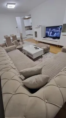 a living room with a couch and a tv at Visoko Prime Residence in Visoko