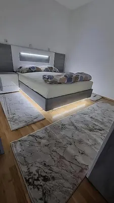 a bedroom with a bed and a rug at Visoko Prime Residence in Visoko