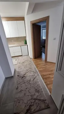 a kitchen with a marble floor and a hallway at Visoko Prime Residence in Visoko