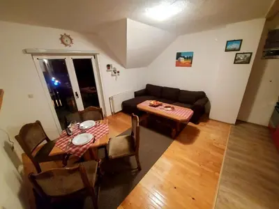 a living room with a couch and a table at Guesthouse Kusić in Kupres