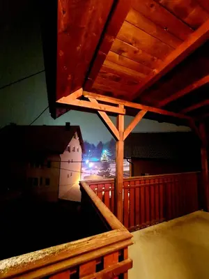 a view from the balcony of a building at night at Guesthouse Kusić in Kupres