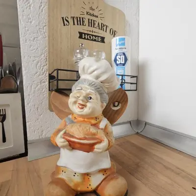 a statue of a chef holding a bowl of food at FRIENDLY HOME in Tuzla