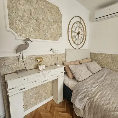 a bedroom with a bed and a desk with a bed sidx sidx sidx at FRIENDLY HOME in Tuzla