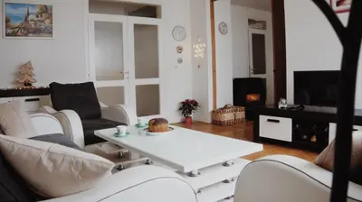 a living room with white furniture and a white coffee table at Apartman Miškec in Kupres