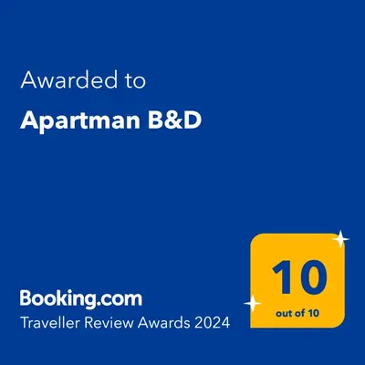 a yellow sign with the text awarded to anarmian bbb at Apartman B&D in Tuzla