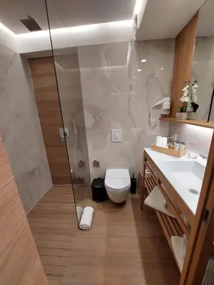 a bathroom with a shower and a toilet and a sink at Lipa Hotel in Travnik