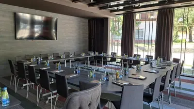 a large conference room with a long table and chairs at Lipa Hotel in Travnik