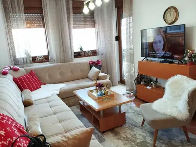 a living room with a couch and a tv at Apartman Royal Vlašić in Vlasic