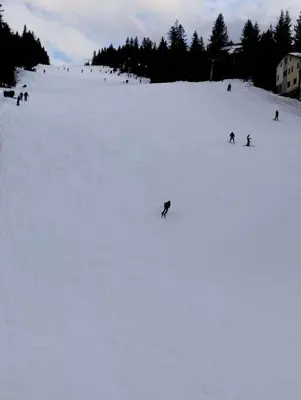 a group of people skiing down a snow covered slope at Apartman Royal Vlašić in Vlasic
