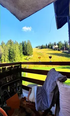 a child laying on a bench looking at a field at Apartman Royal Vlašić in Vlasic