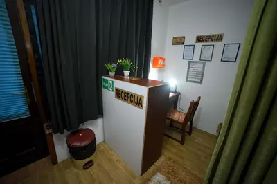 a desk in a room with a table and a chair at Prenoćište KRAJINA in Velika Kladuša
