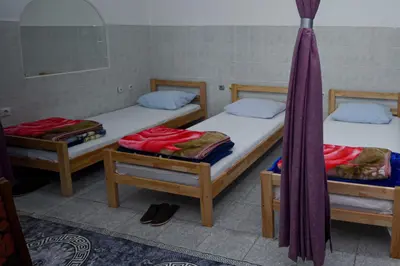 two twin beds in a room with towels on them at Prenoćište KRAJINA in Velika Kladuša