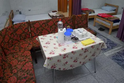 a table with a table cloth on it with drinks on it at Prenoćište KRAJINA in Velika Kladuša