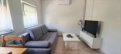 a living room with a couch and a tv at Riverside Panorama Apartment 1 near City Center Brko 1 in Banja Luka