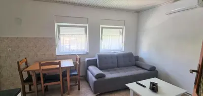 a living room with a couch and a table at Riverside Panorama Apartment 1 near City Center Brko 1 in Banja Luka