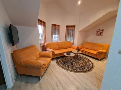 a living room with two couches and a table at Čičak in Livno