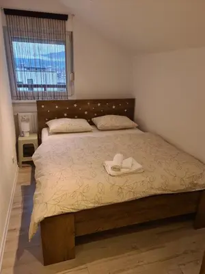 a bedroom with a bed with two hats on it at Čičak in Livno
