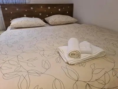 a bed with towels and pillows on it at Čičak in Livno