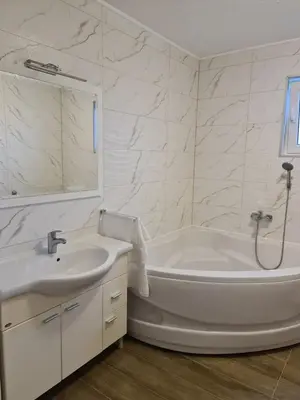 a white bathroom with a tub and a sink at Čičak in Livno