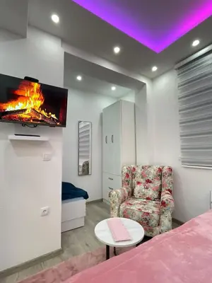 a room with a couch and a tv on a wall at Apartmani Porodica Karalić Vlašić in Vlasic