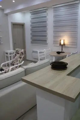 a living room with a couch and a table and chairs at Apartmani Porodica Karalić Vlašić in Vlasic