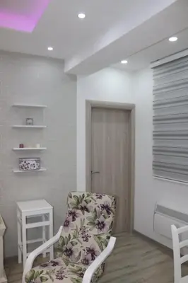 a white room with a chair and a door at Apartmani Porodica Karalić Vlašić in Vlasic