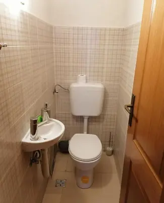 a small bathroom with a toilet and a sink at Winter apartman Vlasic in Šišava
