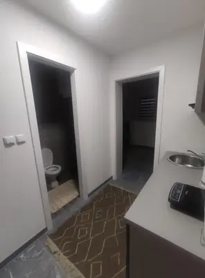 a kitchen with a sink and a toilet in a room at NEER in Živinice