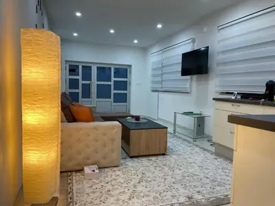 a living room with a couch and a table at Apartman Ćuprija in Cazin