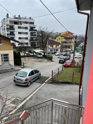 a car parked in a parking lot in a city at Apartman Ćuprija in Cazin