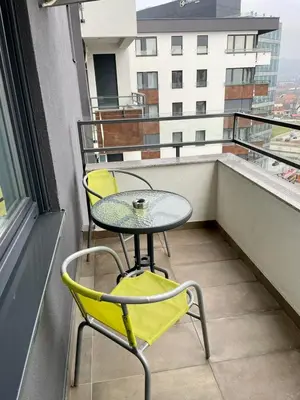 a small table and two chairs on a balcony at Apartment City Park in Banja Luka