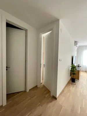 an empty room with a hallway with a door at Apartment City Park in Banja Luka