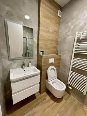 a bathroom with a white sink and a toilet at Apartment City Park in Banja Luka