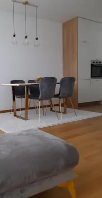 a dining room with a table and chairs at Apartman Lena in Banja Luka