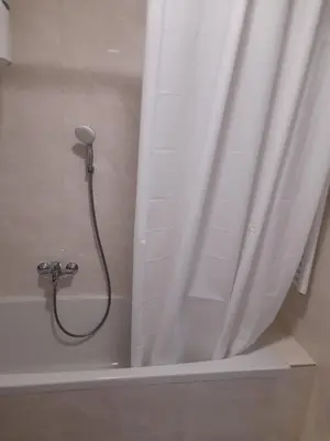 a shower in a bathroom with a shower curtain at Apartman Lena in Banja Luka