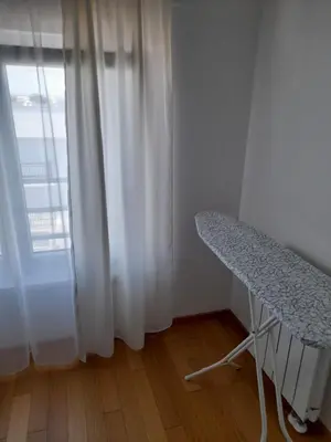 a white room with a table and a window at Apartman Lena in Banja Luka