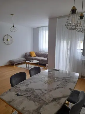 a living room with a table and chairs at Apartman Lena in Banja Luka
