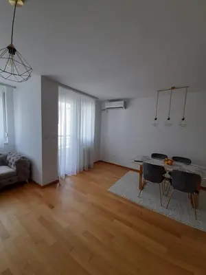 a living room with a table and a couch at Apartman Lena in Banja Luka