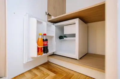 a small white refrigerator with drinks in it at Apartments Hana City Center in Livno