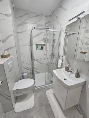 a bathroom with a shower and a toilet and a sink at Apartman Blok 51 in Banja Luka