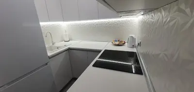 a small kitchen with white cabinets and a sink at Apartman Blok 51 in Banja Luka
